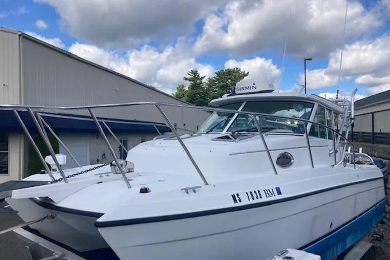 Slide: The Image of 2008 Glacier Bay 2685 Coastal Runner boat docked under cloudy sky. - 4