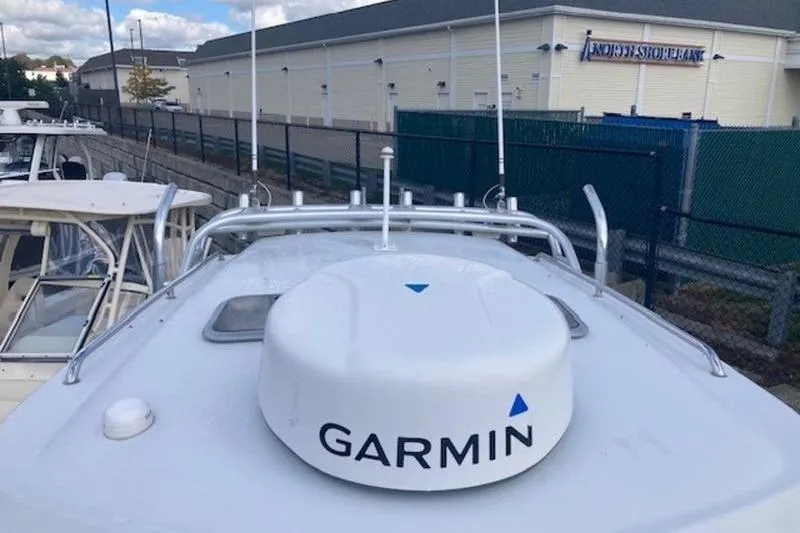Slide: The Image of 2008 Glacier Bay 2685 Coastal Runner with Garmin radar, docked near a building. - 5