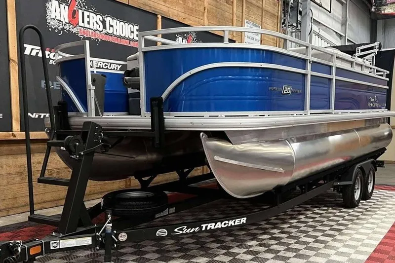 Slide: The Image of 2026 Sun Tracker Fishin' Barge 20 DLX pontoon boat on trailer in showroom. - 3