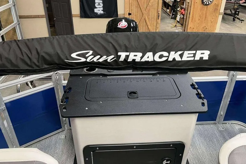 Slide: The Image of 2026 Sun Tracker Fishin' Barge 20 DLX boat interior with branded cover. - 4