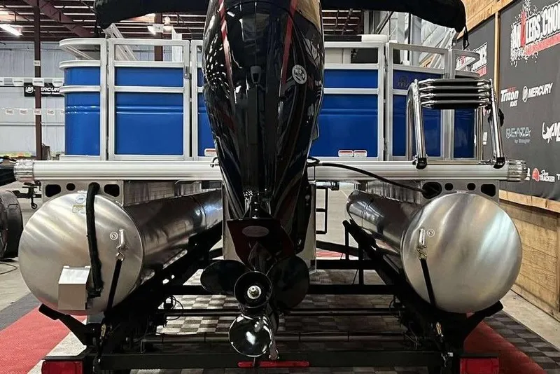 Slide: The Image of 2026 Sun Tracker Fishin' Barge 20 DLX pontoon boat, rear view in showroom. - 5