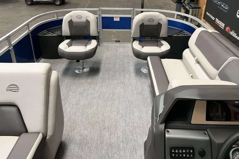 Slide: The Image of 2026 Sun Tracker Fishin' Barge 20 DLX interior with seating and helm. - 6