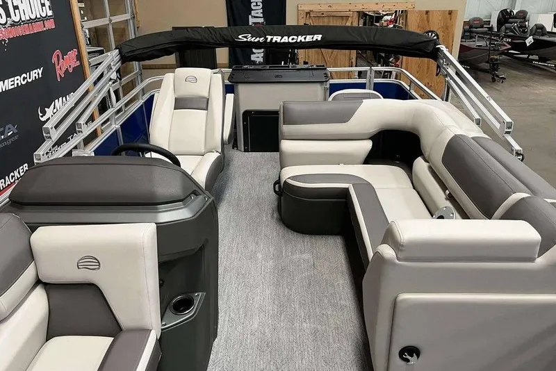 Slide: The Image of 2026 Sun Tracker Fishin' Barge 20 DLX interior with plush seating and modern design. - 7