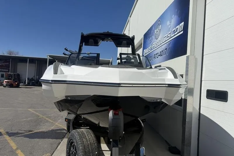 Slide: The Image of 2025 Supra SE 575 boat on trailer outside dealership. - 5