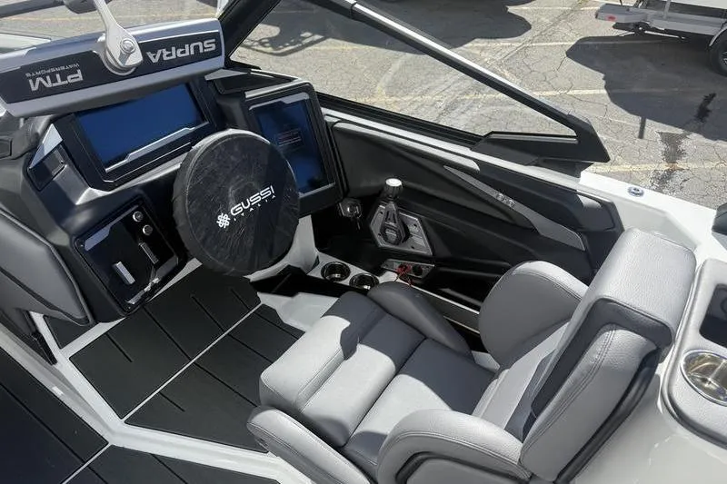 Slide: The Image of 2025 Supra SE 575 boat cockpit with modern controls and comfortable seating. - 9