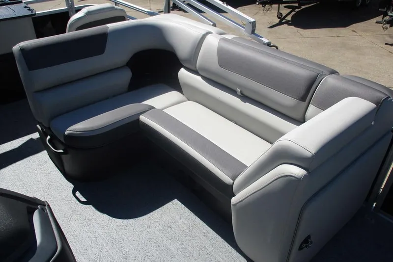 Slide: The Image of 2026 Sun Tracker Fishin' Barge 20 DLX interior seating, featuring gray and black cushioned seats. - 10