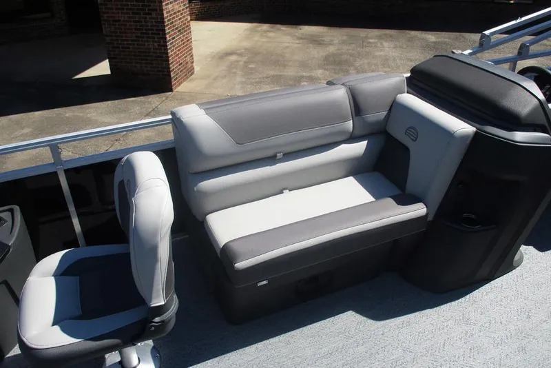 Slide: The Image of 2026 Sun Tracker Fishin' Barge 20 DLX interior seating with gray and white upholstery. - 11