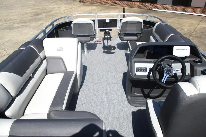 Slide: The Image of 2026 Sun Tracker Fishin' Barge 20 DLX interior with seating and steering console. - 3