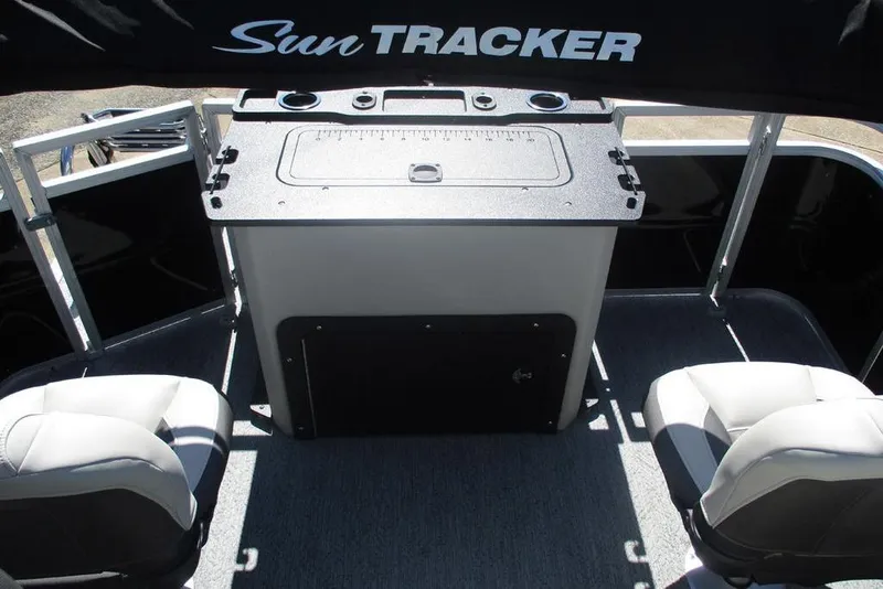 Slide: The Image of 2026 Sun Tracker Fishin' Barge 20 DLX interior with seating and control panel. - 8