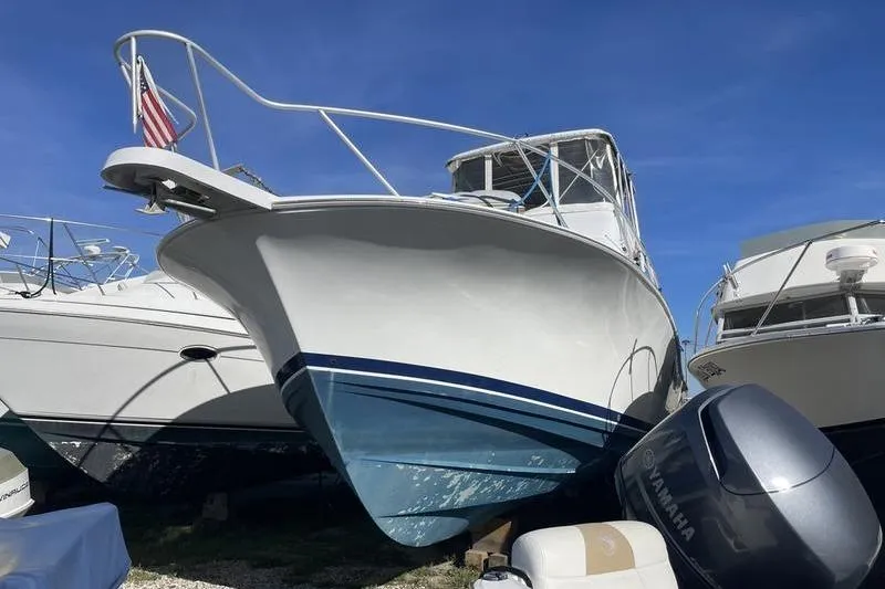 The Image of 1999 Luhrs Tournament 360 boat with Yamaha engine, docked under clear blue sky. - 1