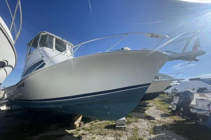 Slide: The Image of 1999 Luhrs Tournament 360 boat on land, clear sky background. - 3