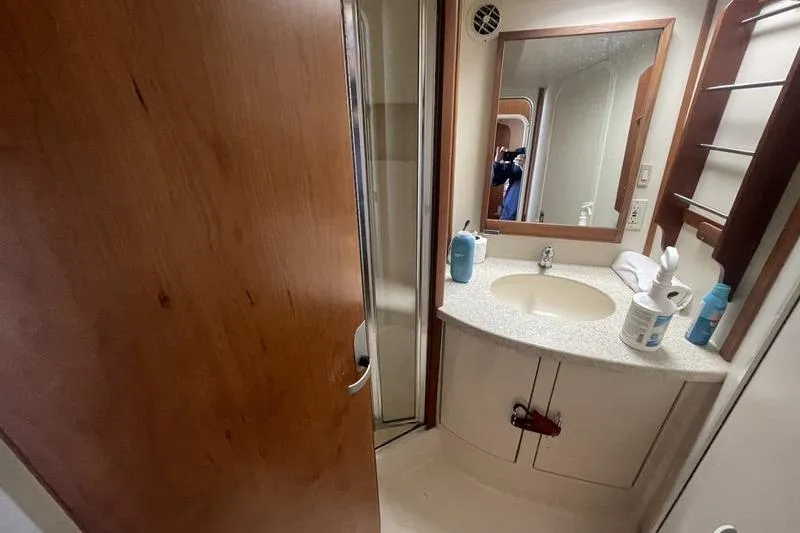 Slide: The Image of Bathroom interior of 1999 Luhrs Tournament 360 yacht with sink and mirror. - 5