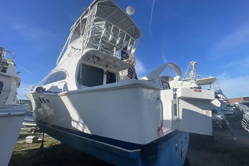 Slide: The Image of 1999 Luhrs Tournament 360 boat with tower, docked under clear blue sky. - 7
