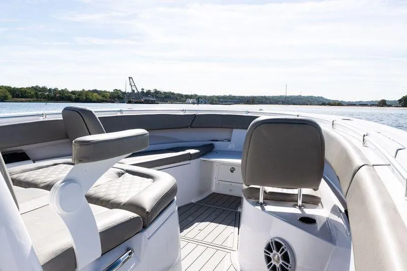 Slide: The Image of 2024 Sportsman Open 322 Center Console boat interior with cushioned seating and ocean view. - 10