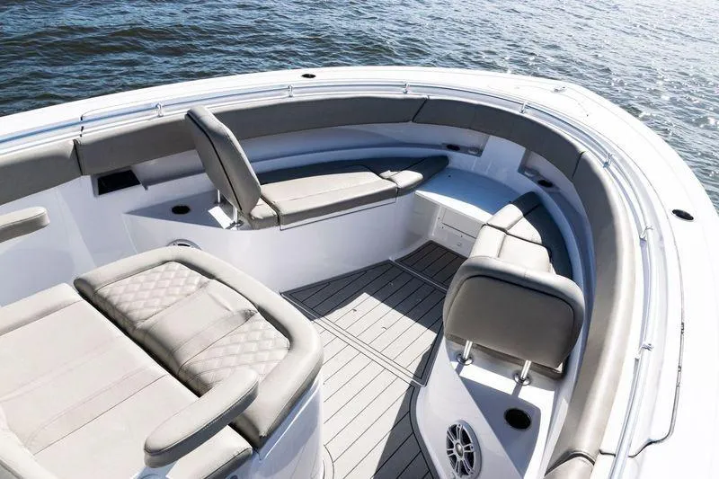 Slide: The Image of 2024 Sportsman Open 322 Center Console boat interior with cushioned seating and scenic water view. - 11