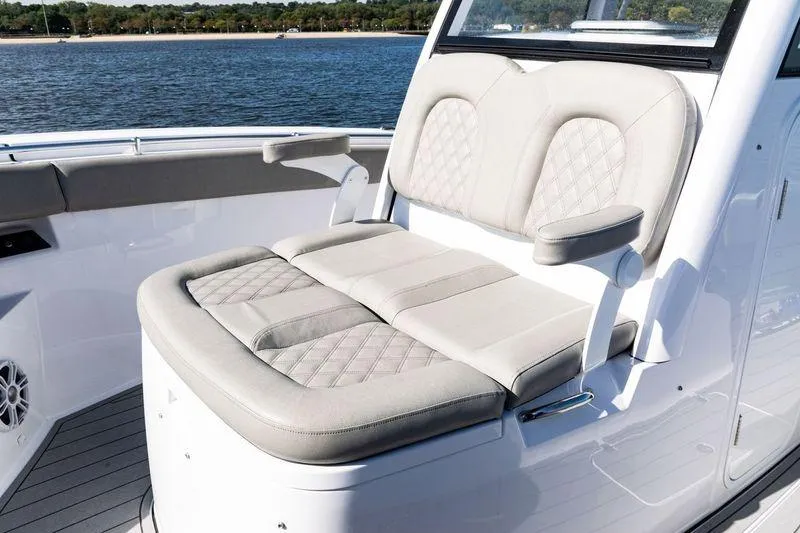 Slide: The Image of 2024 Sportsman Open 322 Center Console boat on calm water, showcasing sleek design. - 17