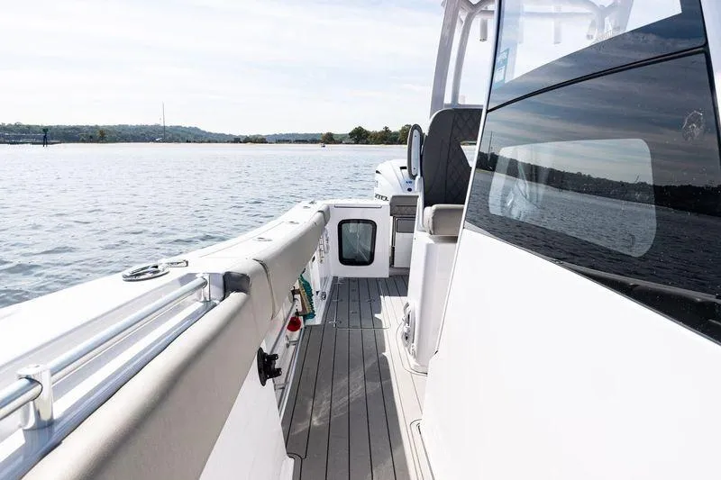 Slide: The Image of 2024 Sportsman Open 322 Center Console boat interior with seating and ocean view. - 18
