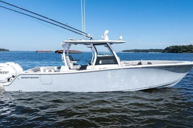 Slide: The Image of 2024 Sportsman Open 322 Center Console boat, aerial view, on dark water. - 2