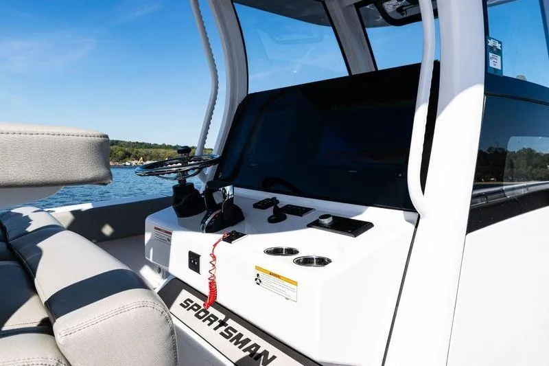 Slide: The Image of 2024 Sportsman Open 322 Center Console boat interior with steering wheel and seating. - 20