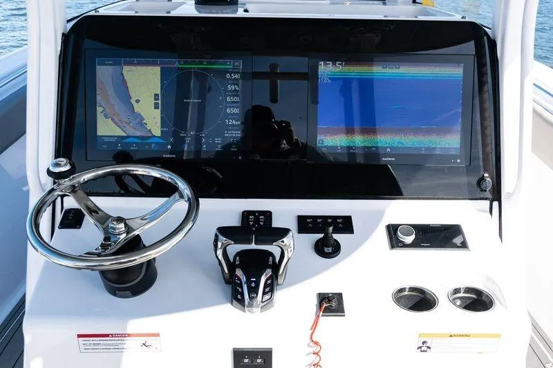 Slide: The Image of 2024 Sportsman Open 322 Center Console boat on water, featuring dual engines. - 22