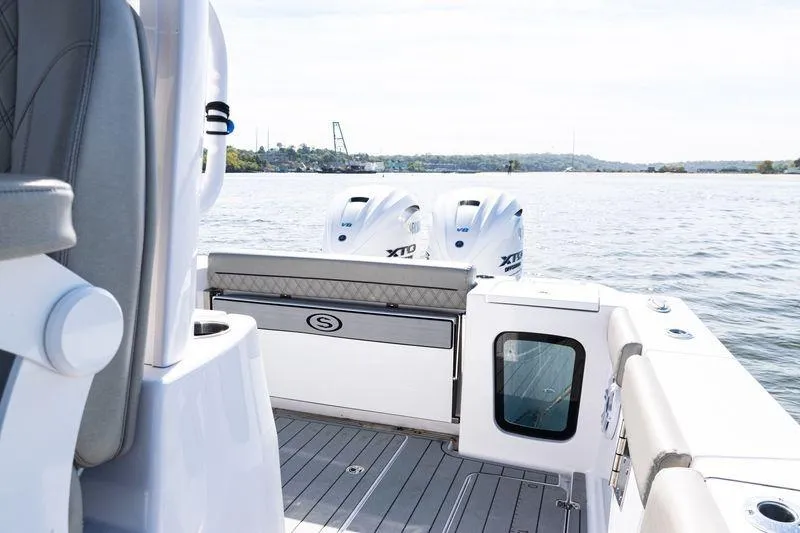 Slide: The Image of 2024 Sportsman Open 322 Center Console boat with twin engines on water. - 23