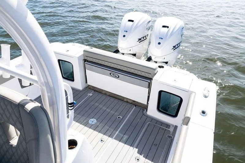 Slide: The Image of 2024 Sportsman Open 322 Center Console boat with twin outboard engines on water. - 24