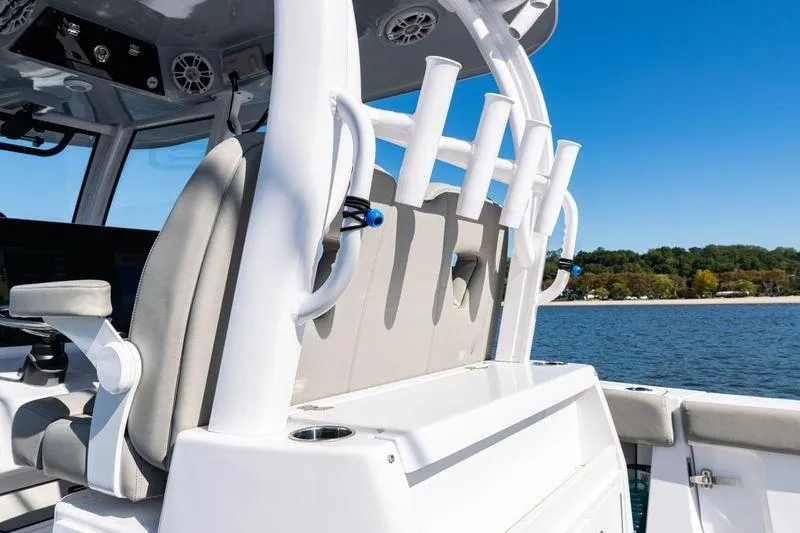 Slide: The Image of 2024 Sportsman Open 322 Center Console boat interior with rod holders and seating. - 28