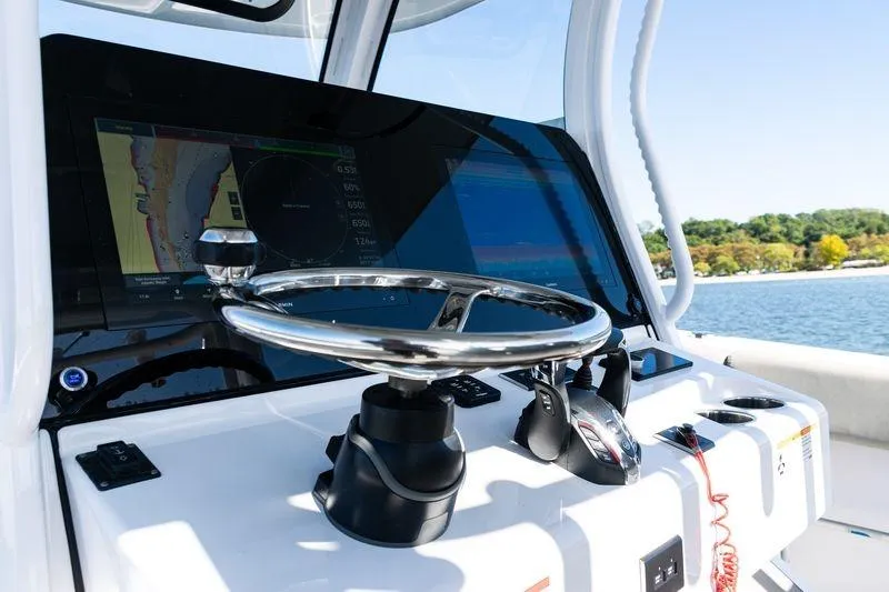 Slide: The Image of 2024 Sportsman Open 322 Center Console with twin XTO Offshore V8 engines on water. - 32