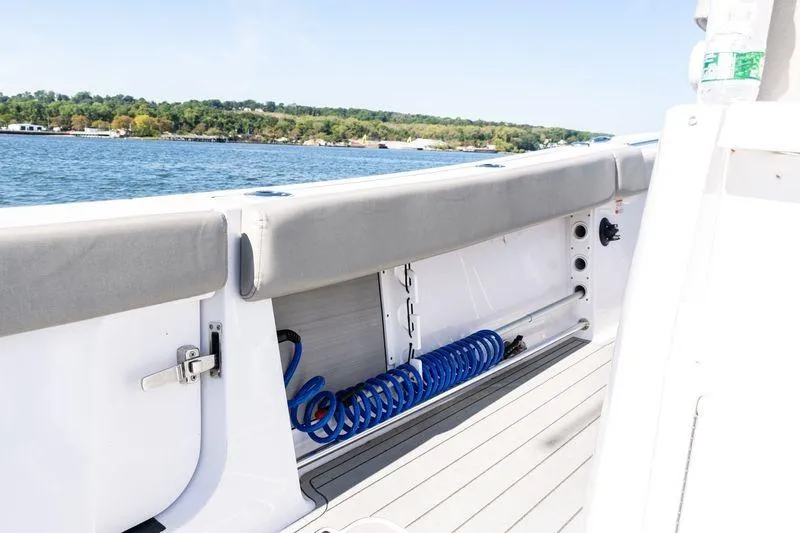 Slide: The Image of 2024 Sportsman Open 322 Center Console boat interior with storage and scenic water view. - 34