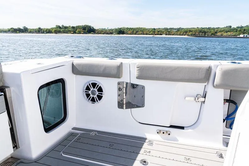 Slide: The Image of 2024 Sportsman Open 322 Center Console boat with dual engines, rear seating, and sleek design. - 37