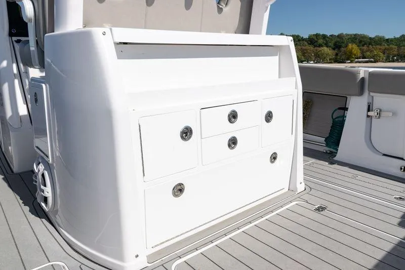 Slide: The Image of 2024 Sportsman Open 322 Center Console boat interior with storage compartments. - 39