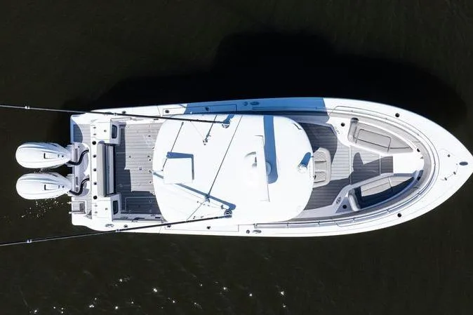 Slide: The Image of 2024 Sportsman Open 322 Center Console boat interior with seating, on calm water. - 8