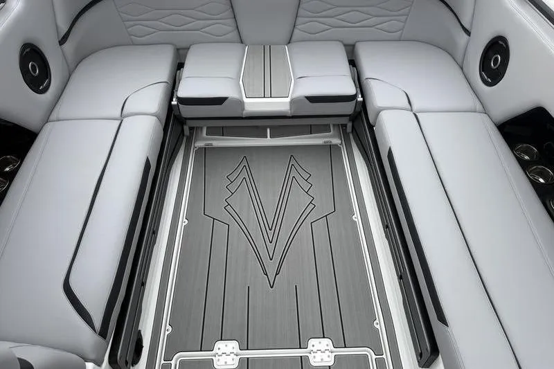 Slide: The Image of 2025 Supra SE 575 boat interior with sleek gray seating and stylish flooring design. - 11