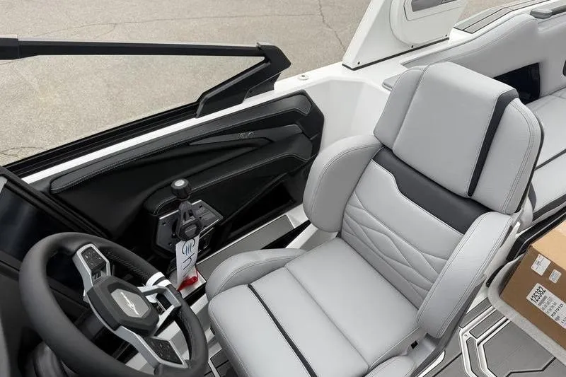Slide: The Image of 2025 Supra SE 575 boat interior with sleek steering wheel and luxurious seating. - 13