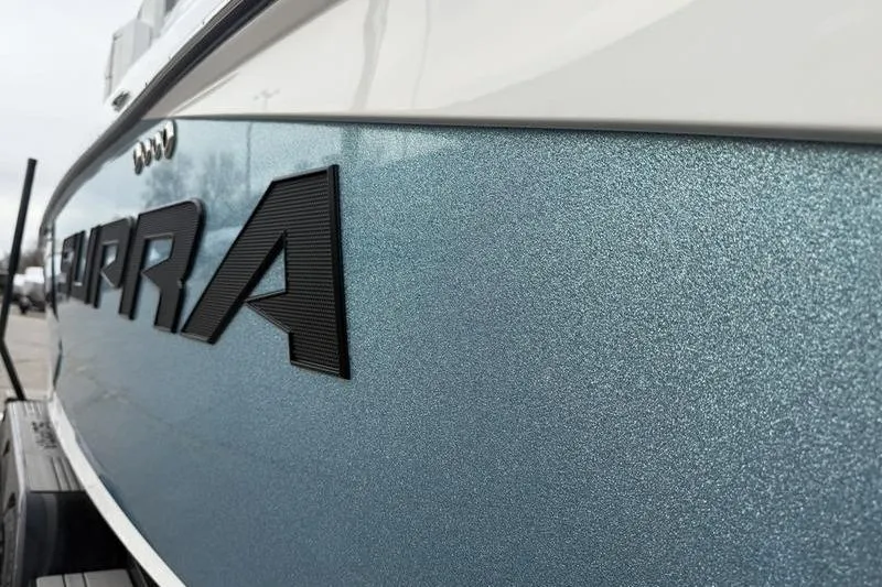 Slide: The Image of 2025 Supra SE 575 boat with metallic blue finish and bold lettering. - 4