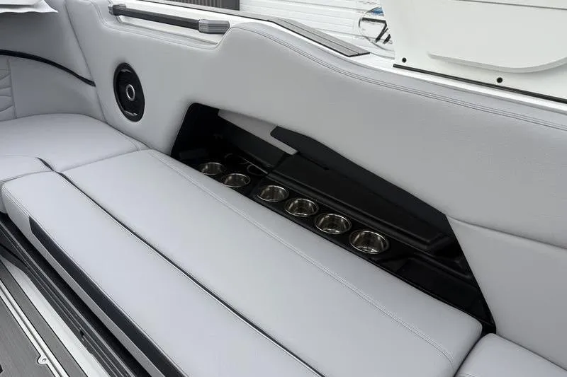 Slide: The Image of 2025 Supra SE 575 boat interior with sleek seating and integrated cup holders. - 8