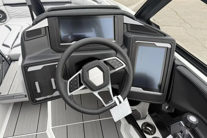 Slide: The Image of 2025 Supra SE 575 boat dashboard with modern steering wheel and digital displays. - 9