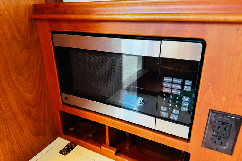 Slide: The Image of Built-in microwave in 2012 Hinckley Picnic Boat MKIII with wooden cabinetry. - 10
