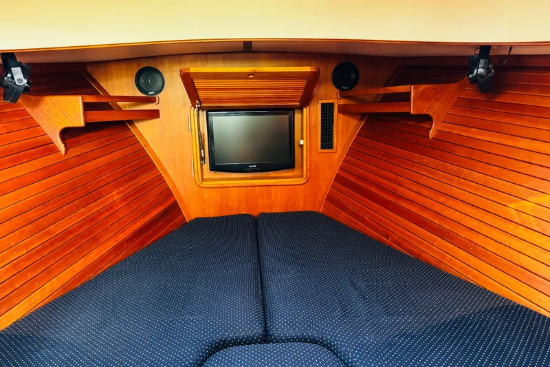 Slide: The Image of Interior of 2012 Hinckley Picnic Boat MKIII with wood paneling and TV. - 2