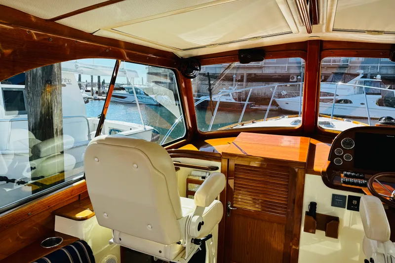 Slide: The Image of Interior of 2012 Hinckley Picnic Boat MKIII with helm and marina view. - 30