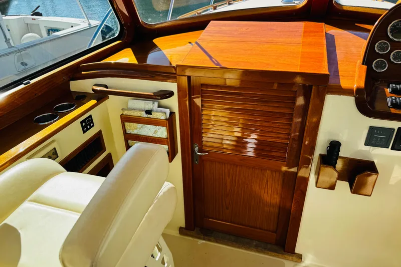 Slide: The Image of Interior of 2012 Hinckley Picnic Boat MKIII with polished wood and leather seating. - 43