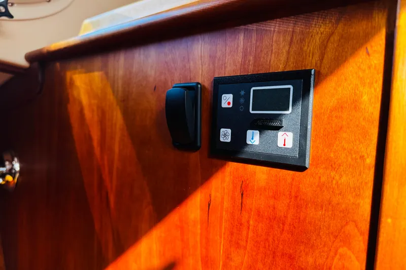 Slide: The Image of Control panel on 2012 Hinckley Picnic Boat MKIII's wooden interior. - 45