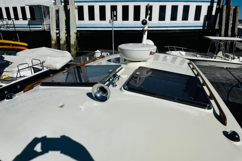Slide: The Image of 2012 Hinckley Picnic Boat MKIII docked, showcasing deck features and sleek design. - 53