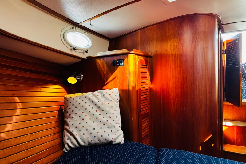 Slide: The Image of Cozy cabin interior of 2012 Hinckley Picnic Boat MKIII with wooden paneling and cushion. - 6