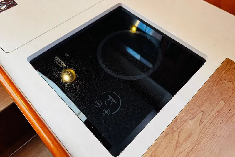 Slide: The Image of Hinckley Picnic Boat MKIII 2012 features a sleek Kenyon electric cooktop in the galley. - 11