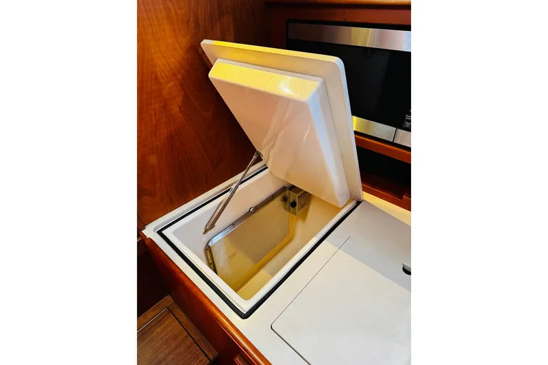 Slide: The Image of Hinckley Picnic Boat MKIII 2012 interior with open storage compartment. - 12