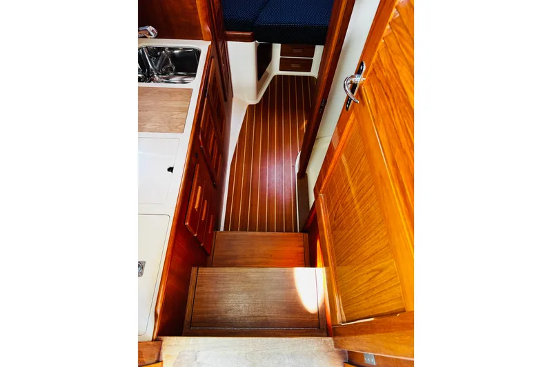 Slide: The Image of Interior of 2012 Hinckley Picnic Boat MKIII with wooden cabinetry and flooring. - 16