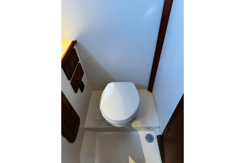 Slide: The Image of Hinckley Picnic Boat MKIII 2012 interior showing compact marine toilet setup. - 18