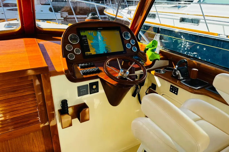 Slide: The Image of Interior of 2012 Hinckley Picnic Boat MKIII with wooden dashboard and navigation system. - 22