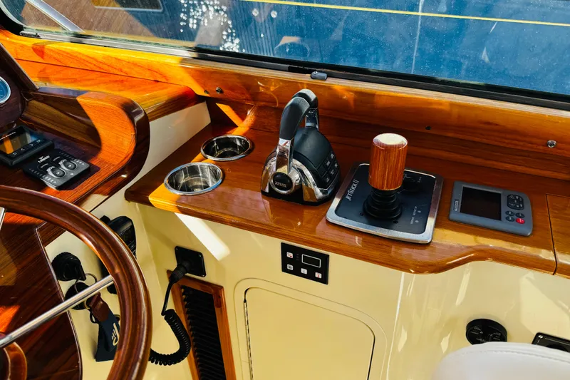 Slide: The Image of Hinckley Picnic Boat MKIII 2012 helm with wooden accents and modern controls. - 23